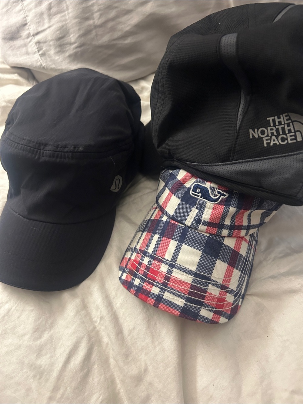 Vineyard Vines, black Lululemon and North Face women’s baseball caps